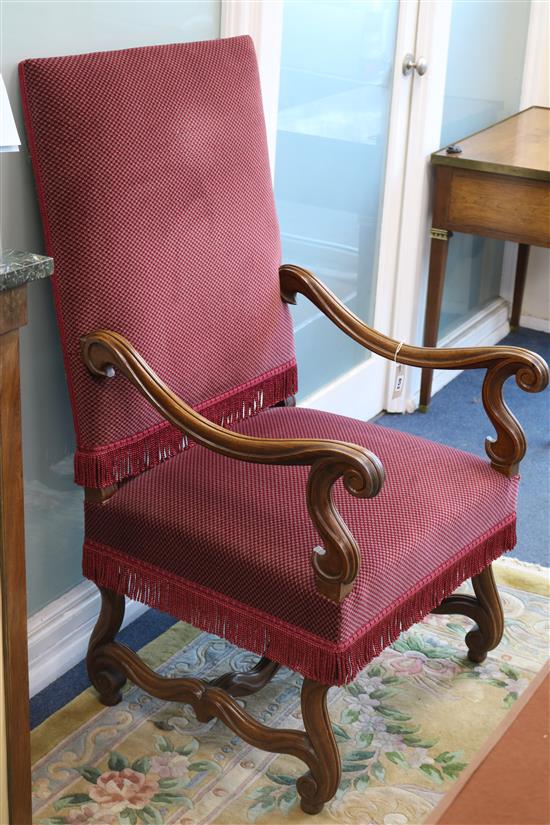 A Louis XIV style carved walnut open armchair